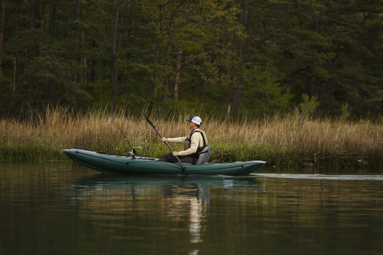 Caucasian man fishing on kayak