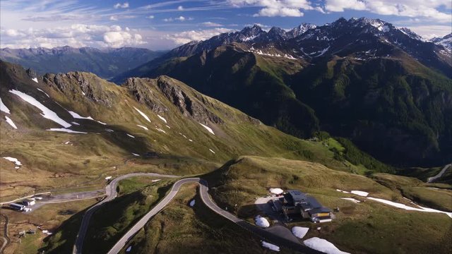 Wide aerial shot of house on mountain pass / Grossglockner, Carinthia, Austria