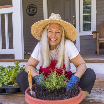 Portrait of senior woman planting seedling