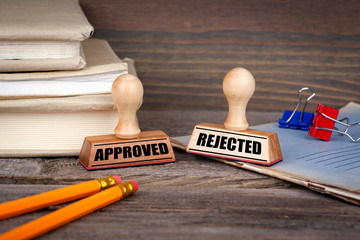 approved and rejected. Rubber Stamp on desk in the Office. Business and work background.