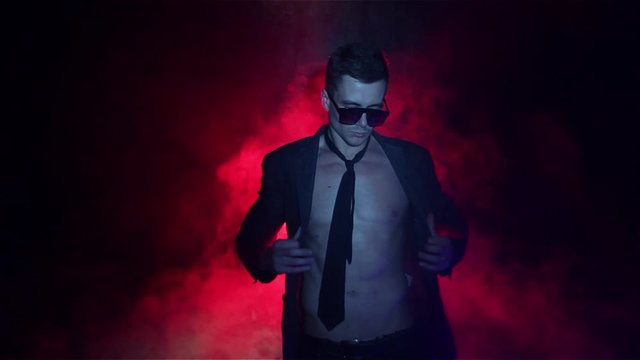 Sexy man dancing on smoke background