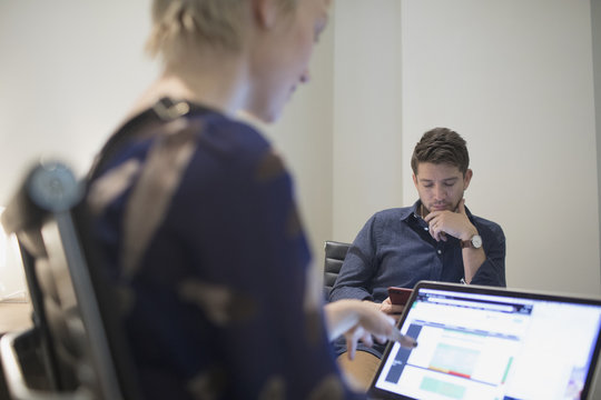 Young man and woman working in an an office.