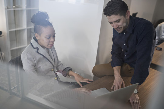 Young man and woman working in an an office.
