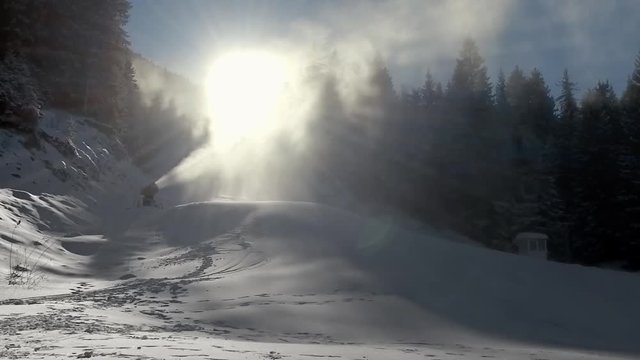 Large snow gun generates artificial snow on ski slope, SLOW MOTION