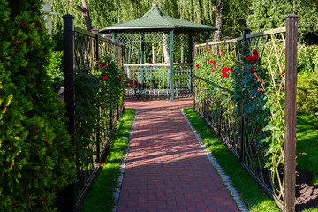 summerhouse in a landscape park in summer