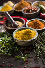 Herbs and spices on a wooden background 