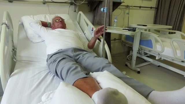 Elderly 70 Plus Year Old Man Recovering From Surgery In A Hospital Bed