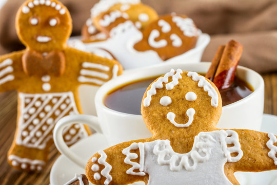 The romantic still life on topic Christmas or New Year - Homemade christmas gingerbreads with a cup of coffee on wooden boards