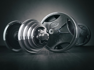 Barbell and dumbell. Sports bodybuilding equipment on black background. Fitness or healthy lifestyle concept.