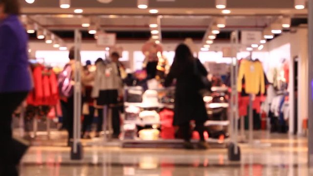 Shopping in mall, walking people, blurred background. Time lapse.