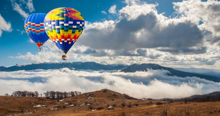 Colorful hot-air balloons flying over the mountain.Artistic picture. Beauty world.