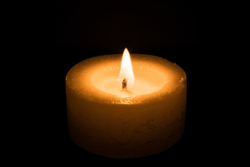 candle burns at dusk, a candle fire on a black background