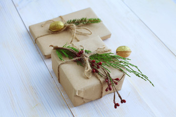 Christmas gift boxes and fir tree branch on wooden table. Сhristmas background