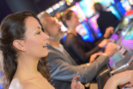 group of people playing slot and various machines