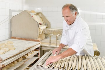 Baker preparing baguettes