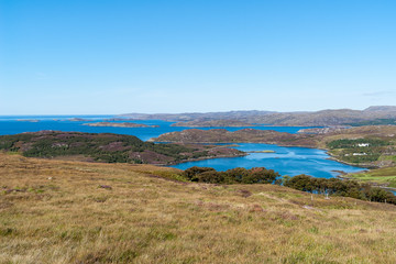 Typical Scottish Highlands seascape with islands ans isolated houses - Western Highlands, Scotland, UK