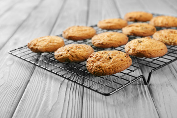 Delicious oatmeal cookies with raisins on wooden table