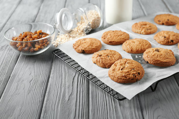 Delicious oatmeal cookies with raisins on wooden table