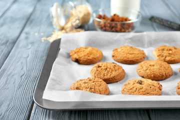 Delicious oatmeal cookies with raisins on tray