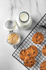 Delicious oatmeal cookies with chocolate chips on metal grid
