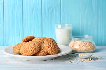 Plate with delicious oatmeal cookies on table