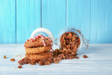 Delicious oatmeal cookies with raisins on wooden table