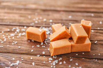 Salted caramel candies on wooden table