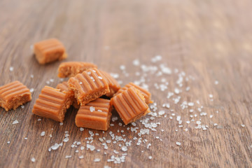 Salted caramel candies on wooden table