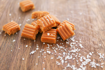 Salted caramel candies on wooden table