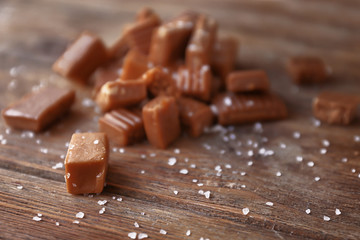 Salted caramel candies on wooden table