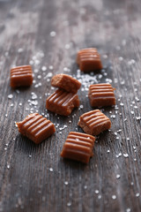 Salted caramel candies on wooden table