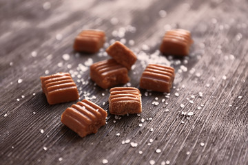 Salted caramel candies on wooden table