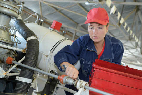 engineer maintaining a helicopter engine