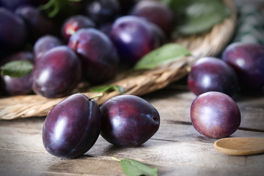 Fresh delicious plums on table, closeup