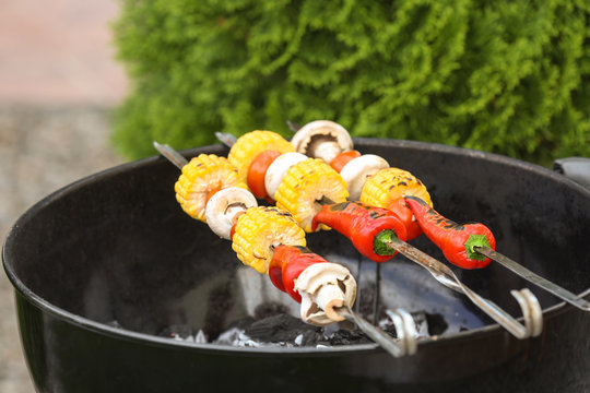 Tasty vegetables cooking on barbecue grill, outdoors
