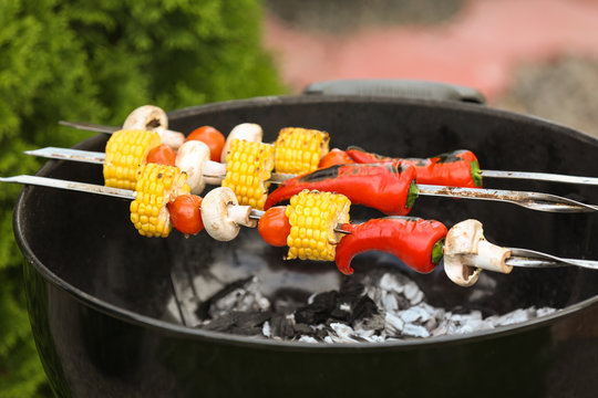 Tasty vegetables cooking on barbecue grill, outdoors