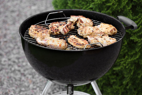 Tasty meat cooking on barbecue grill, outdoors