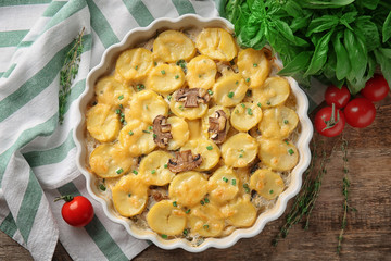 Baking dish with potato casserole on table