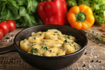 Frying pan with potato casserole on table