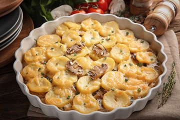 Baking dish with potato casserole on table