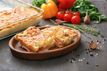 Plate with potato casserole on table