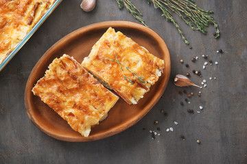 Plate with potato casserole on table