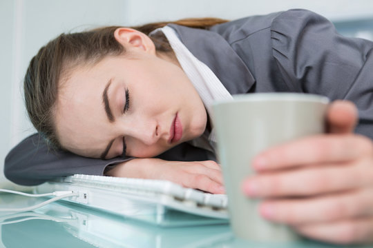 young businesswoman sleeping in office