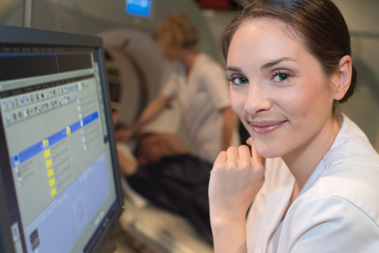 female doctor watching scan results on computer