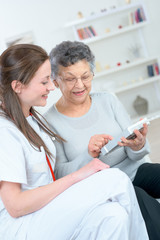 elderly woman holding her pills while medical check up