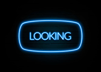 Looking  - colorful Neon Sign on brickwall