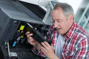Man working on professional printer