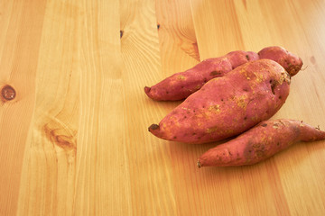 Sweet potatoes on a rustic wooden table