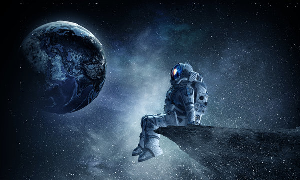 Spaceman on rock edge. Mixed media