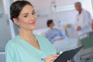 Portrait of nurse holding clipboard